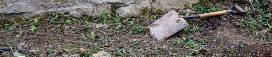 spade on ground by wall of kiln