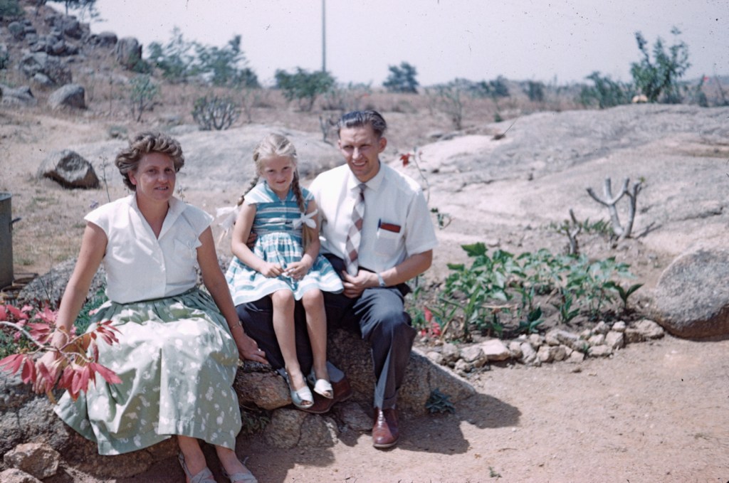 Parents and child sitting in a garden, Northern Nigeria, early 1960s. Author's family.