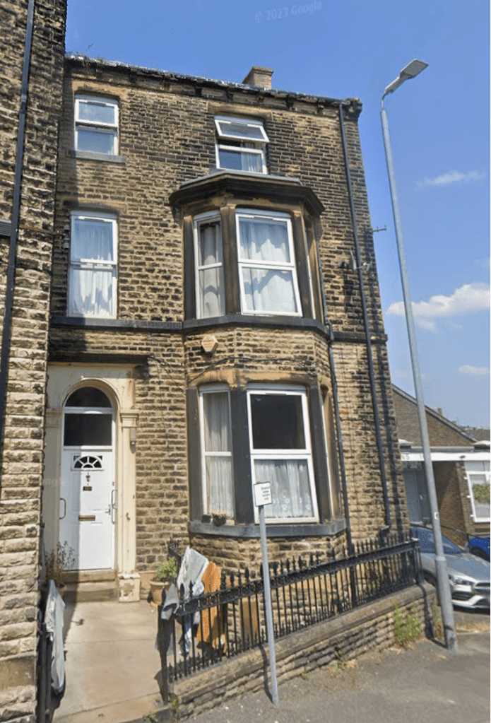 A Victorian-story town house next to a modern commercial building. 