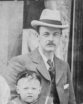 Frank looking dapper in suit and hat with snall son Willie dressed in a sailor suit.