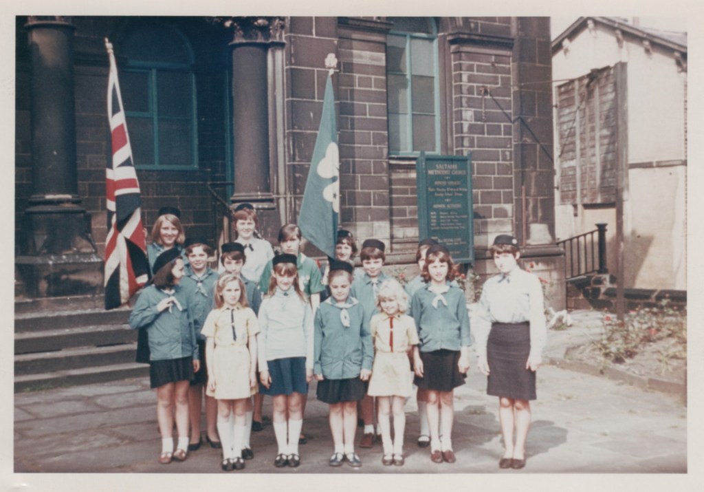 Guide company outside chapel, ready for church parade with Union flag and Guide standard.